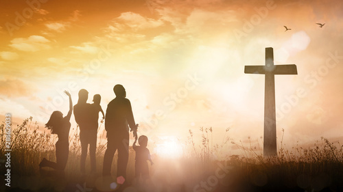 Big family worship concept: Silhouette people looking for the cross on autumn sunrise background