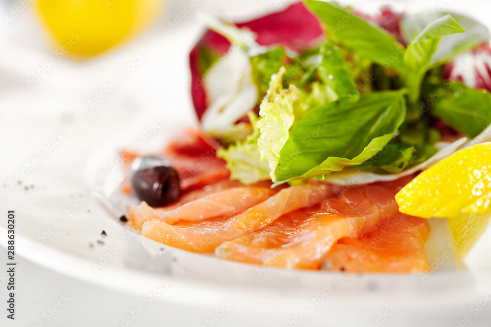 Gourmet, restaurant, delicious dinner food - close up of Fish Dish with Lemon and Fresh Basil Leaves Gourmet, restaurant, delicious dinner food - close up of Fish Dish with Lemon and Fresh Basil Leaves