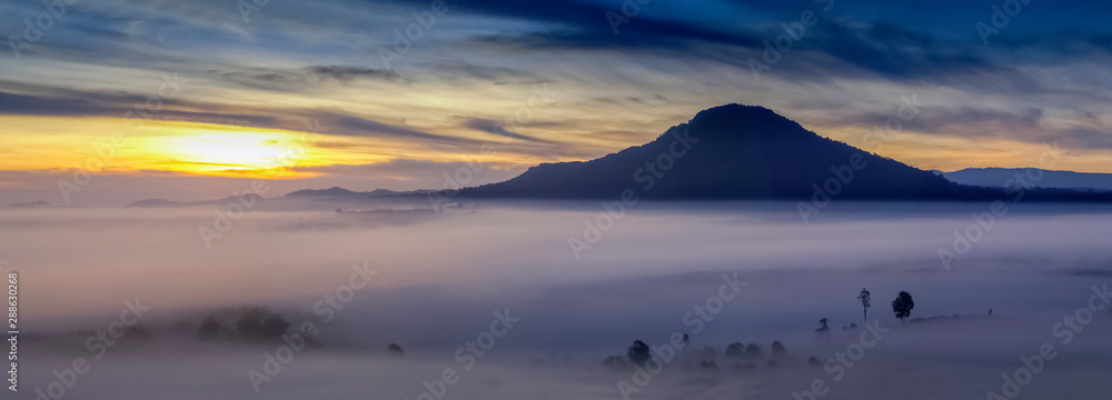 Mountain view panorama 180 degree morning of top hills and forest in valley around with sea of fog with cloudy sky background, sunrise at Khao Takhian Ngo (Takian Ngo), Khao Kho, Phetchabun, Thailand.