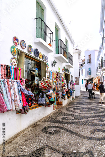  A narrow steep shopping alley in Frigiliana, one of Andalucia's famous "White Villages" on the Costa del Sol in Southern Spain.