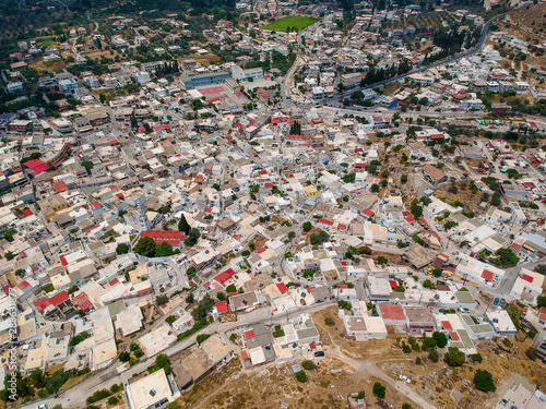 Aerial birds eye view drone photo ancient Archangelos scenic old town with castle on Rhodes island, Dodecanese, Greece. Beautiful picturesque white houses. Famous tourist destination in South Europe