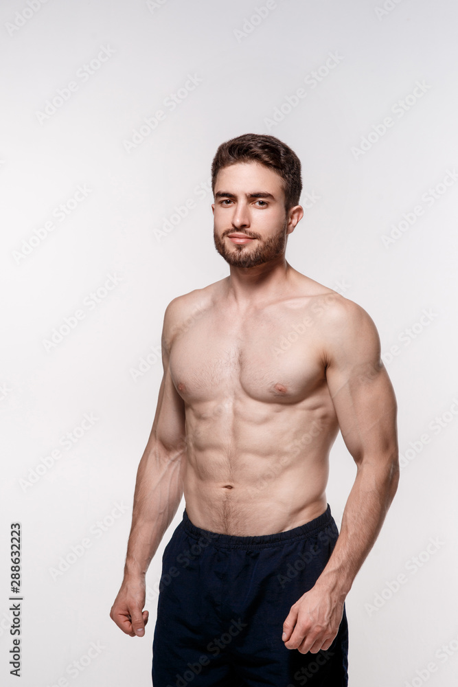 athletic man on a white background. handsome bearded athlete looking forward.