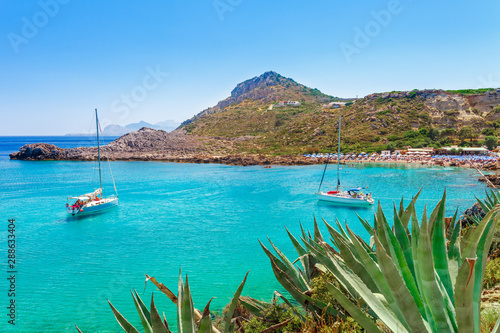 Fototapeta Naklejka Na Ścianę i Meble -  Sea skyview landscape photo Ladiko bay near Anthony Quinn bay on Rhodes island, Dodecanese, Greece. Panorama with nice sand beach and clear blue water. Famous tourist destination in South Europe