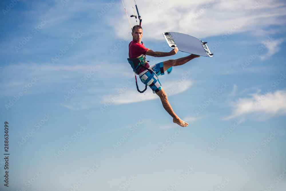 Professional kiter makes the difficult trick on a beautiful background. Kitesurfing Kiteboarding action photos man among waves quickly goes Professional kiter makes the difficult trick on a beautiful background. Kitesurfing Kiteboarding action photos man among waves quickly goes