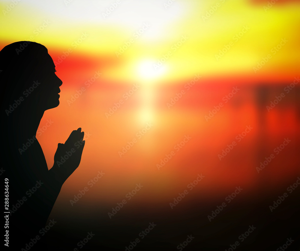 Forgive concept: Silhouette prayer woman pray to God on autumn sunset background