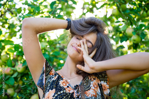 Girl in the morning in the garden . Good morning. Awakening in the morning. Traveling in the summer. Portrait of a beautiful smiling girl outdoor. 