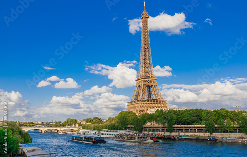 Panoramic cityscape of Seine river, Eiffel Tower in Paris, France, Europe. Eiffel Tower is the symbol of Paris. Famous tourist architecture destination. View of Seine postcard in Paris