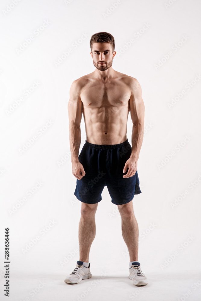 athletic man on a white background. handsome bearded athlete looking forward. athletic man on a white background. handsome bearded athlete looking forward.