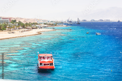 EILAT, ISRAEL - JUNE 14, 2014: Redboat with tourists at sea in the bay of Eilat, Israel.  photo