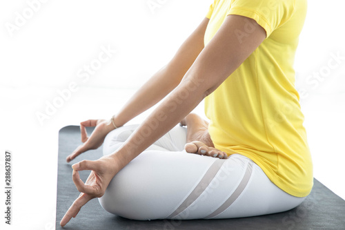 Asian women meditate while practicing yoga, independent concepts, relaxing women 's happiness, calm, white room backdrop.