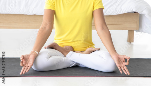 Asian women meditate while practicing yoga, independent concepts, relaxing women 's happiness, calm, white room backdrop.