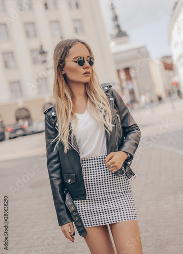 Stylish girl posing in the street. Fashion summer photo.