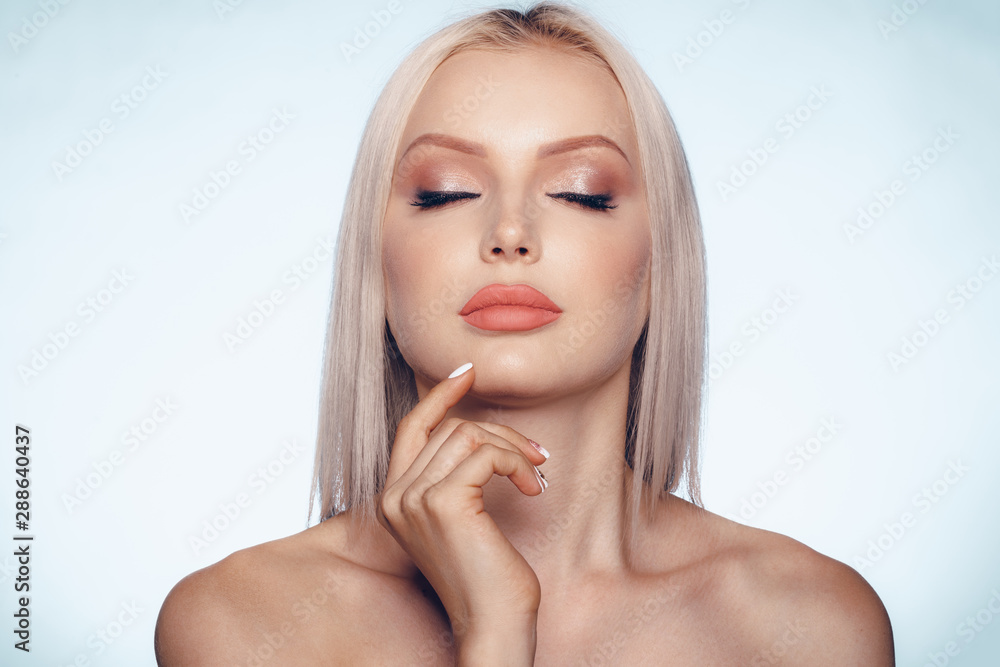 Close up beauty portrait of a blonde woman with perfect skin and plump lips Close up beauty portrait of a blonde woman with perfect skin and plump lips