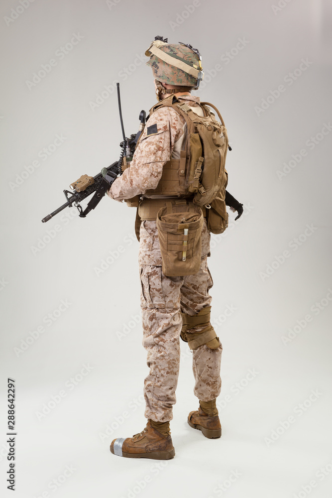 Rear view of military soldier US army marines operator studio shot portrait Rear view of military soldier US army marines operator studio shot portrait