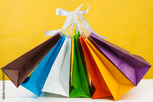 Paper shopping bags on bright yellow background © fotofabrika