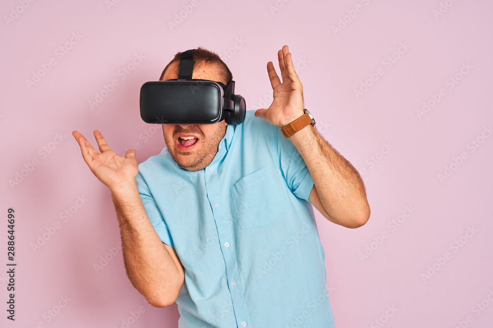 Young plus size man playing virtual reality game using goggles Young plus size man playing virtual reality game using goggles