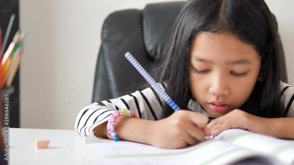 Asian little girl doing homework select focus shallow depth of field Asian little girl doing homework select focus shallow depth of field