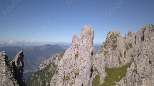 Drone aerial video of special rocks in Grigna mountain, in summer season, near Lecco, Lombardy, Italy. Famous, climbing area of Ragni di Lecco the association to which Walter Bonatti belonged. photo