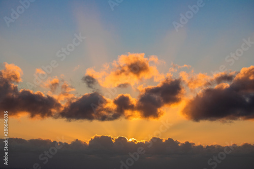 Sun setting over a golden blue sunset over the ocean. © Global News Art