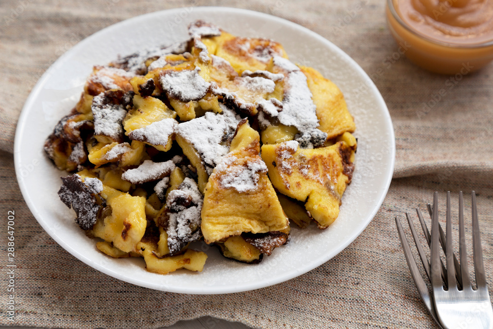 Homemade german Kaiserschmarrn pancake on a white plate, low angle view. Closeup. Homemade german Kaiserschmarrn pancake on a white plate, low angle view. Closeup.