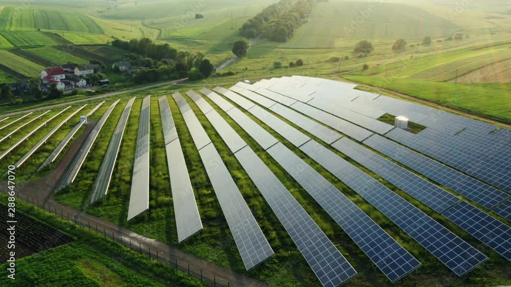 Aerial view to solar power plant. Industrial background on renewable resources theme.