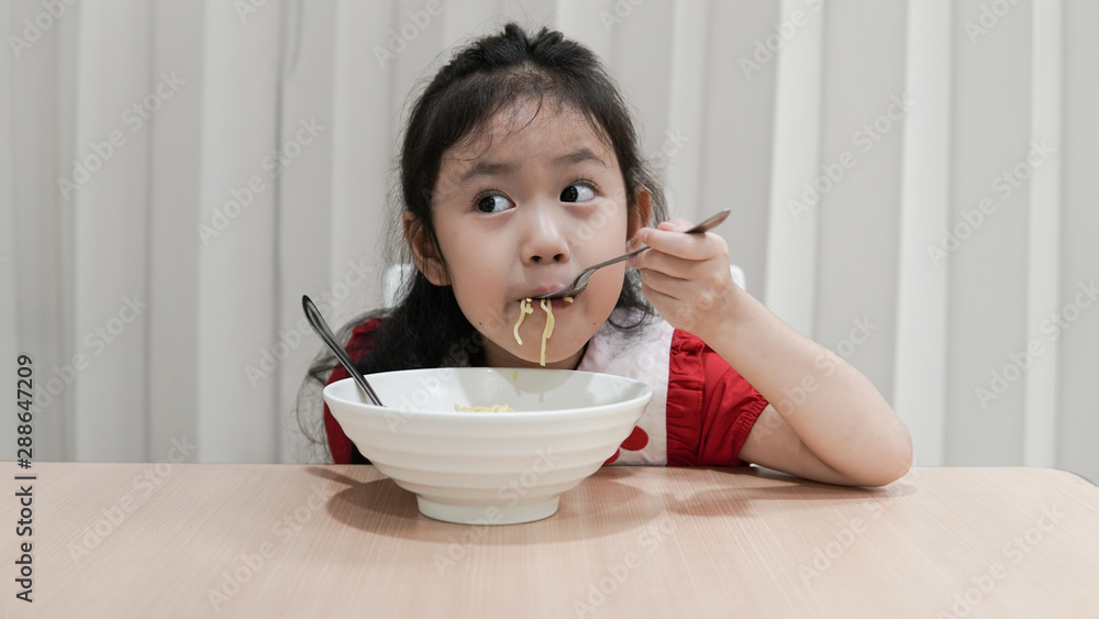 Asian little cute girl enjoy eating noodle Asian little cute girl enjoy eating noodle