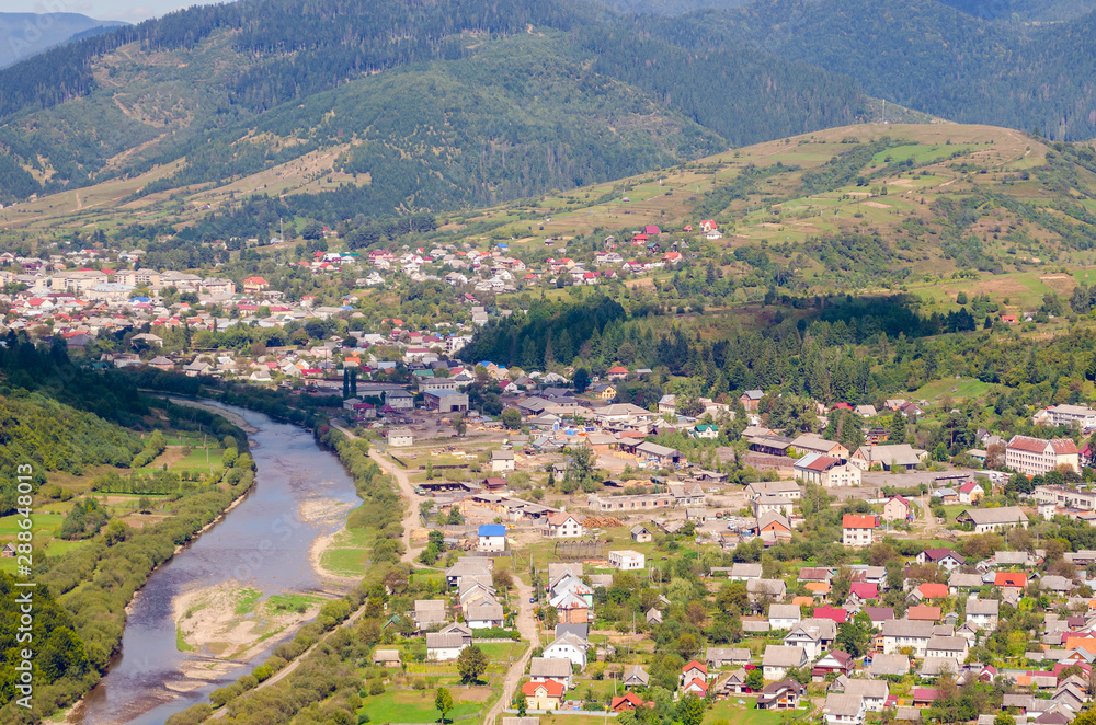 Naklejka premium Ukraine Carpathians, a settlement in a valley of mountains, beautiful landscape aerial view