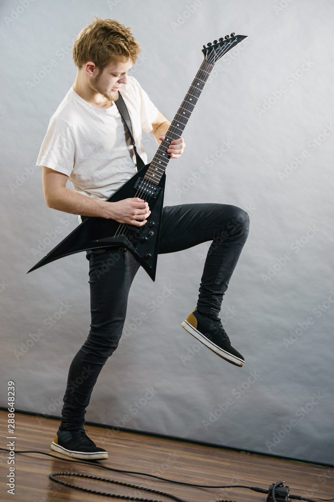 Fototapeta premium Man playing on electric guitar