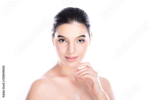 Beauty woman face isolate in white background. Young caucasian girl, perfect skin, cosmetic, spa, beauty treatment concept. One finger touching jaw, smile.