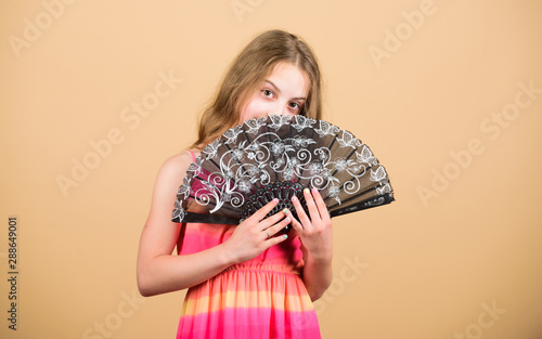 Dances with fan. Girl fanning herself with fan. Air circulation. Art and culture. Handheld fan create airflow. Airflow from handfans increases evaporation. Cooling effect. Folding fans. Acting school photo