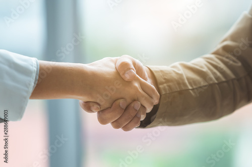 close up man and woman shaking hands for partner, Business concept.