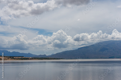 Beautiful nature landscape with lake, mountains and stormy clouds