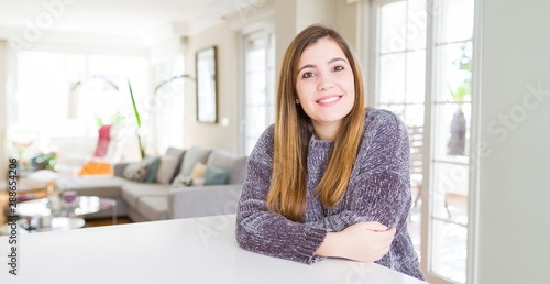 Beautiful young woman at home with a happy and cool smile on face. Lucky person.