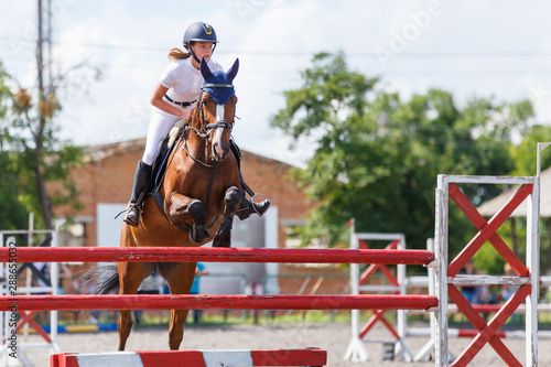 Horse rider woman on show jumping competition © skumer