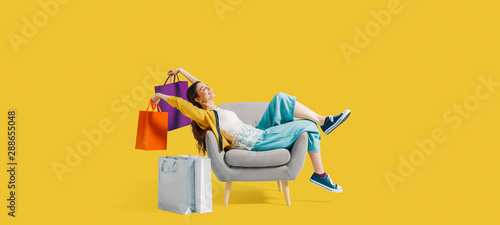 Cheerful shopaholic woman with shopping bags photo