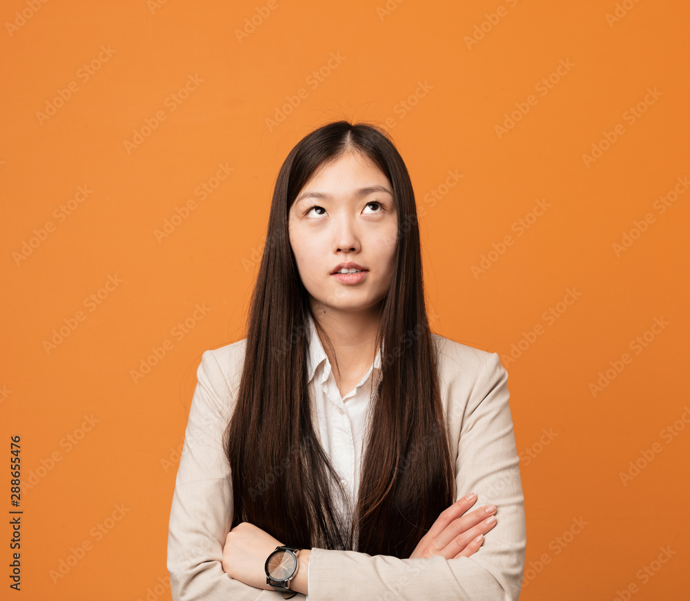 Young business chinese woman tired of a repetitive task. Young business chinese woman tired of a repetitive task.