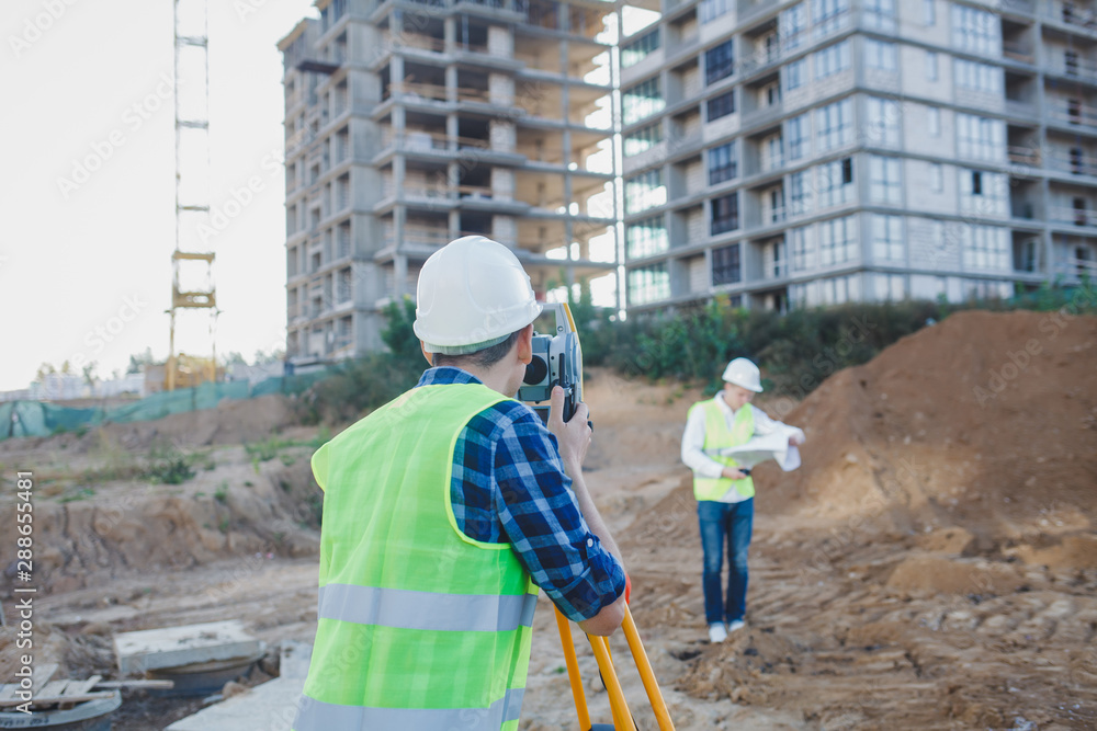 two engineers surveyor with construction equipment two engineers surveyor with construction equipment