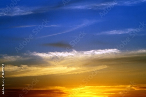 amazing unreal toned fantasy sunset or sunrise partially cloudy sky for using in design as background.