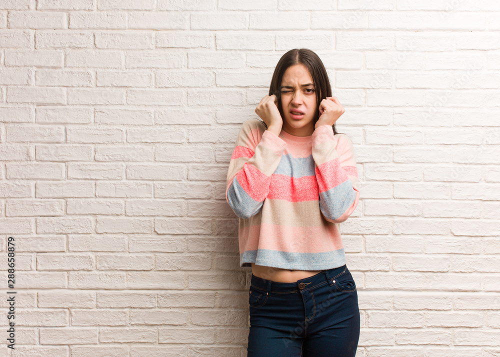 Young modern woman covering ears with hands Young modern woman covering ears with hands