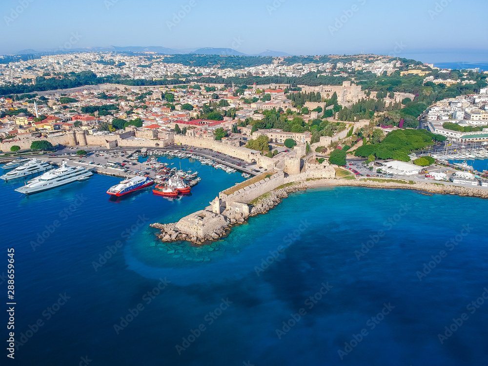 Aerial birds eye view drone photo of Rhodes city island, Dodecanese, Greece. Panorama with Mandraki port, lagoon and clear blue water. Famous tourist destination in South Europe