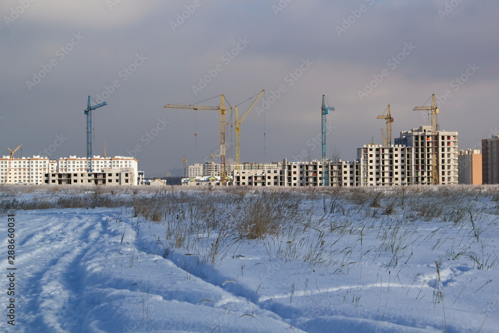 Obraz premium construction of a new apartments residential building in the winter season