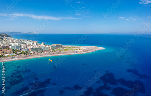 Aerial birds eye view drone photo of Elli beach on Rhodes city island, Dodecanese, Greece. Panorama with nice sand, lagoon and clear blue water. Famous tourist destination in South Europe