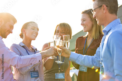 Wall Mural Business colleagues toasting wineglasses during rooftop success party