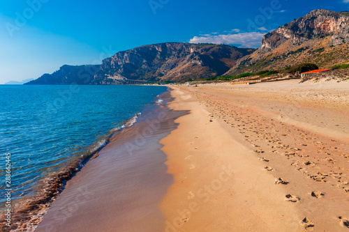 Fototapeta Naklejka Na Ścianę i Meble -  Panoramic sea beach landscape near Gaeta, Lazio, Italy. Nice sand beach and clear blue water. Famous tourist destination in Riviera de Ulisse. Bright sunny light and sunset.