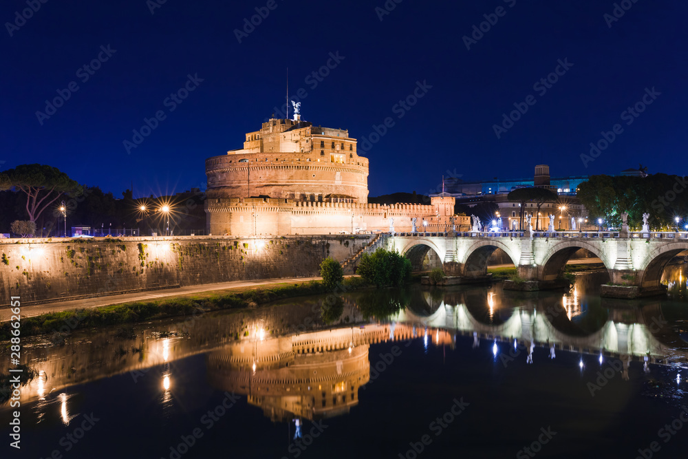 Cityscape romantic night view of Roma. Panorama with Saint Angelo castle and bridge. Famous tourist destination with Tiber. Travel illuminated landscape in Italy, Europe.