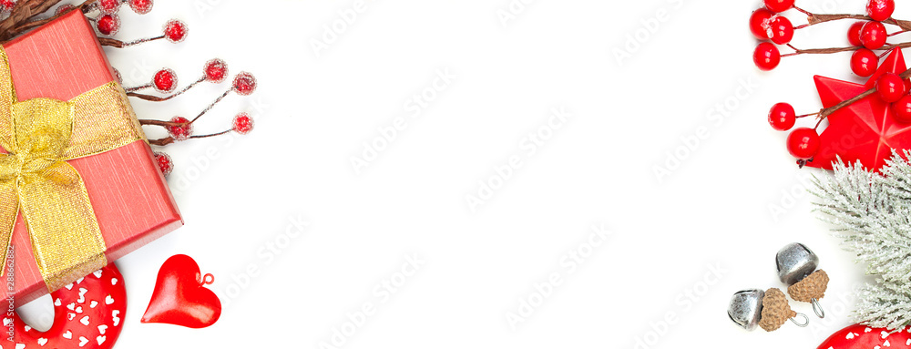 Bright Christmas background border with green Xmas tree twig, gift and red New Year decoration isolated on white background Bright Christmas background border with green Xmas tree twig, gift and red New Year decoration isolated on white background