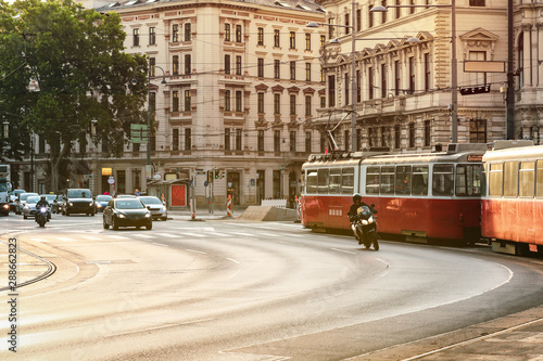 Photography Old fashioned tram goes by the street of Vienna