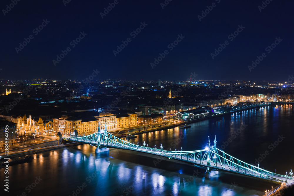 Fototapeta premium Night view of Budapest. Panorama cityscape of famous tourist destination with Danube and bridges. Travel illuminated landscape in Hungary, Europe.