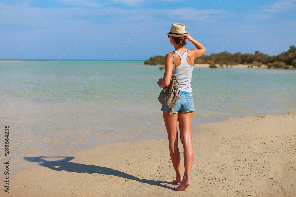Tourist woman at the Red Sea coast and mangroves in the Ras Mohammed National Park. Famous travel destionation in desert. Sharm el Sheik, Sinai Peninsula, Egypt.