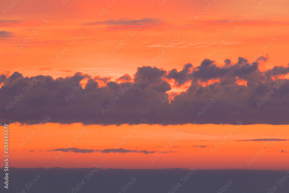 The sunset or sunrise. The cloudy sky cloured in red, orange, rose, scarlet, crimson, purple, violet and blue bright and vivid coloures in the evening or in the morning